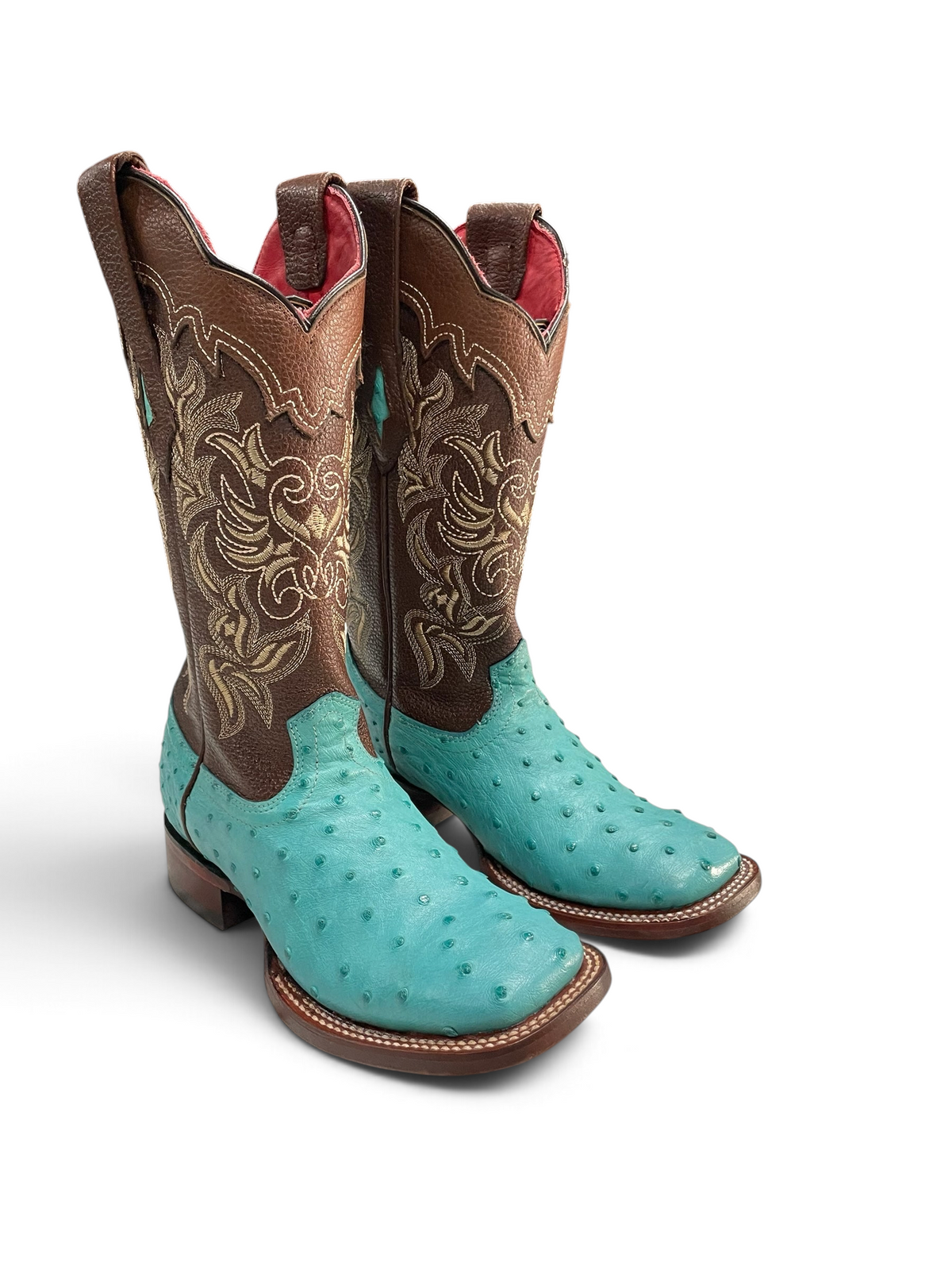 Botas vaqueras Botas El Pistolero PYP de piel de avestruz turquesa con caña café y bordados florales, punta cuadrada.