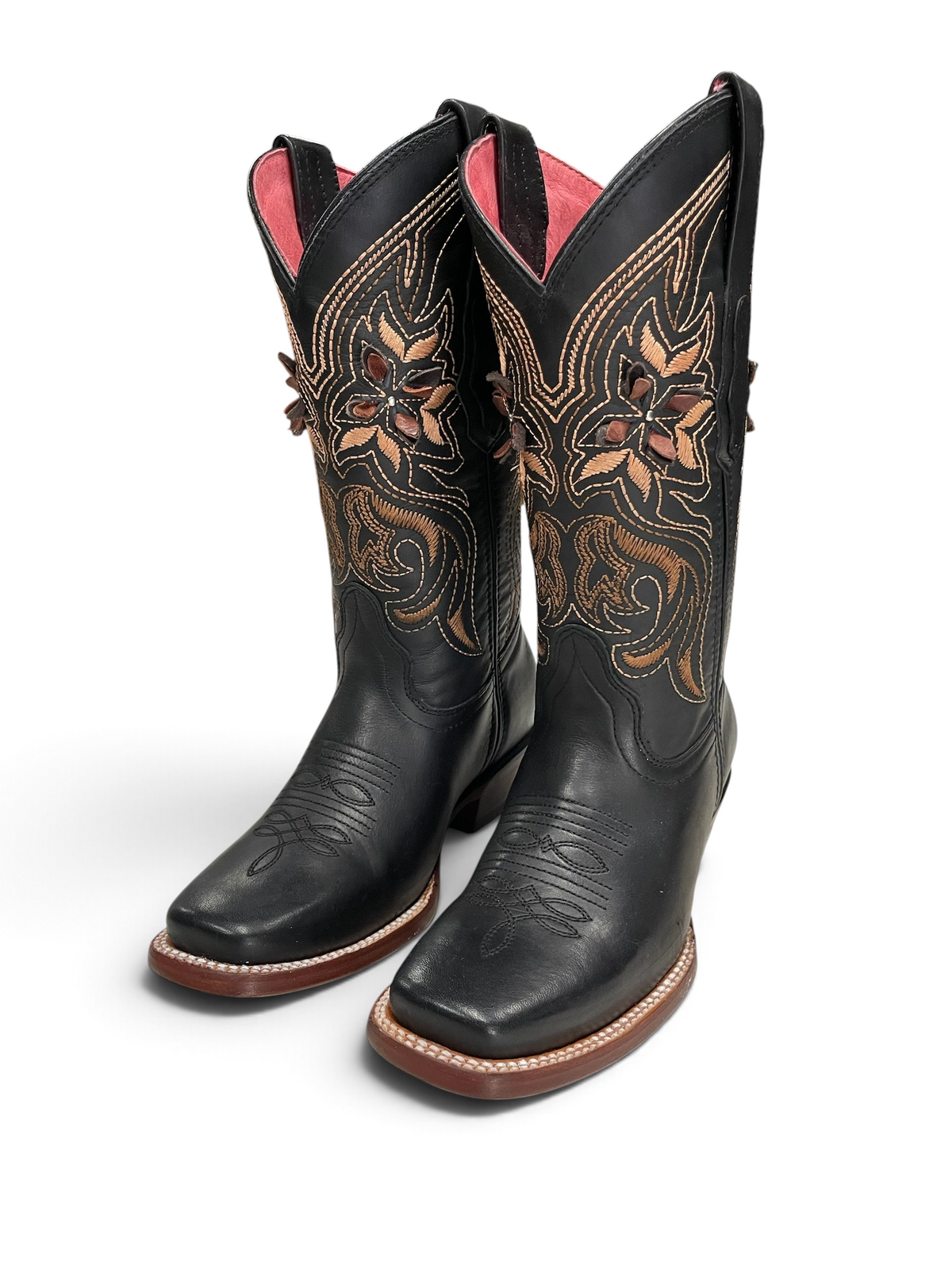 Botas vaqueras Botas El Pistolero PYP de cuero negro con bordado floral en tonos tierra y forro interior rosa.